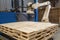 palletizing robot picking up and placing wooden pallets with ease