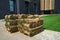 Pallets with sod turf grass. The stacked fresh sod rolls for new grass lawn in residential area.
