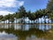 Palm beach, tropical paradise, tree reflecting on the water, seaside, blue sky.