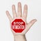 On the palm of the hand there is a stop sign with the inscription - STOP INTIMIDATION