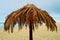 Palm leaf beach umbrella on Baltic beach.