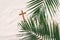 Palm Sunday concept. Cross made of palm and tropical leaves on sand background. Christian moveable feast to celebrate