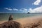 Palm tree stump in front of Mokolii island also known as Chinamans Hat as seen from Kualoa Regional Park on the North Shore of