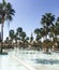 Palm trees around the fountain against the backdrop of a mosque. Jordan, Aqaba