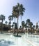 Palm trees around the fountain against the backdrop of a mosque. Jordan, Aqaba