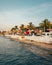 Palm trees and buildings along the water at sunset, in Cozumel, Mexico