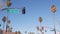 Palm trees in city near Los Angeles, street road sign, semaphore traffic lights.