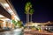 Palm trees and the exterior of the Convention Center at night in