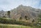 Palm trees in front of arid rocky terrain. Huge barren mountain in background. Santo Antao Island, Cape Verde