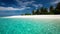 Palm trees over lagoon with white beach in Maldives