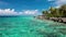 Palm trees over tropical lagoon with white beach