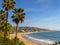 Palm trees proudly sway hi above the golden sands of Laguna Beach