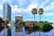 Palm trees in small island, colorful amphitheater and buildings at Lake Eola Park in Orlando Downtown area.