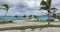 Palm trees swinging in the wind,beach and the sea in the background,Bahamas