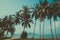 Palm trees on tropical coast and island on horizon