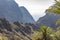 Between the palm trees you have views of the rugged mountains around Masca and a small piece of the island of La Gomera, Tenerife,