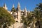 Palma Mallorca cathedral Santa Maria La Seu side view palm trees blue sky sunny