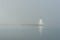 Palmer Island lighthouse vivid in fog