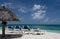 Palms, beach chairs and palm leaf umbrellas on beautiful Cocobay beach - 1