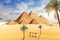 Palms, camels and famous Pyramids of Giza, Cairo, Egypt