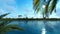 Palms island and aircraft passing against blue sky