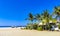 Palms parasols sun loungers beach waves Puerto Escondido Mexico