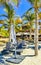 Palms parasols sun loungers beach waves Puerto Escondido Mexico