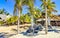 Palms parasols sun loungers beach waves Puerto Escondido Mexico