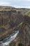 The Palouse river flowing at the base of ancient cliffs at Palouse Falls State Park, Washington, USA