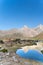 The Pamir range view and peaceful campsite on Kulikalon lake in Fann mountains in Tajikistan. Amasing colorful reflection in pure