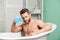 Pampering and beauty routine. Handsome muscular man relaxing bathtub. Warm bath concept. Transform your bathroom into