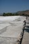 Pamukkale Park, Turkey. View along a wooden walkway to the dry travertine terraces on a sunny day