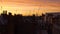 Pan across vivid sunset over roofs and chimneys of Central London