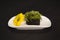 Pan Asian Chuka seaweed gunkan sushi with Hiyashi wakame and sesames on white plate. Sushi restaurant menu close up.