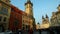 Pan from crowd on tower at Prague central square