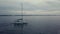 Pan+follow 4k aerial of sailing boat in sunset cloudscape