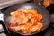 Pan with large, tasty and warm orange prawns, while cooking on the stove