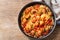 Pan of pasta with meatballs on a wooden background