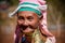 Pan Pet, Kayah State, Myanmar - February 2020: Portrait of an elderly Kayan longneck woman or Paduang wearing pink headdress