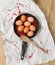 Pan with red pepper, eggs and wooden spoon on a paper and canvas