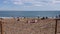 Pan seascape tourists relax and sunbathe on Sant Miquel beach in Barceloneta Spain