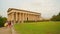 Pan shot of beautiful green territory near ancient temple, antique architecture