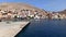 Pan shot of Emporio port of halki / chalki island and houses located on a hills of Greece in the Dodecanese archipelago in the