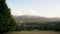 Pan shot of a green grass field meadow panorama against landscape of tatra mountains in the countryside of Zakopane village