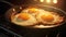 Pan with sizzling yummy fried eggs and melting butter bathed filling air with breakfast aroma