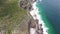 Pan up aerial video view of coastline at Cape Point area with Lighthouse