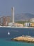 Pan view of Benidorm Poniente beach with port, skyscrapers, boats and mountains in Benidorm, Alicante, Spain with rain clouds on b