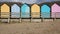 Pan view of numerous colourful English beach huts traditional English structure and shelter found at the seaside