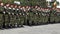 Pan view over an army platoon, troops, at a parade