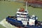 Panama Canal tug boat assisting to the cargo ships.